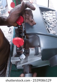 A close-up view of a modern duplicate key-making machine in use, showcasing the intricate process of key cutting in Kolkata.