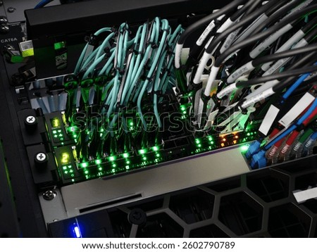Close-up view of a modern network switch with vibrant LED lights and organized cables, showcasing advanced technology and data transmission infrastructure.