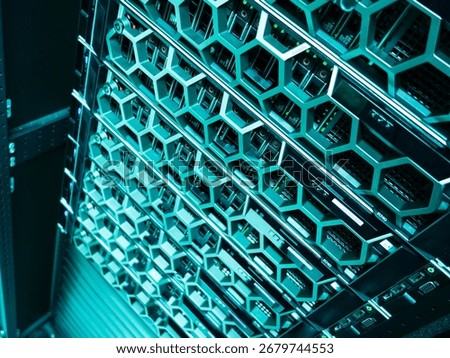 A close-up view of a modern server rack displaying multiple hardware units, illuminated with LED indicators, showcasing advanced technology in a data center environment.