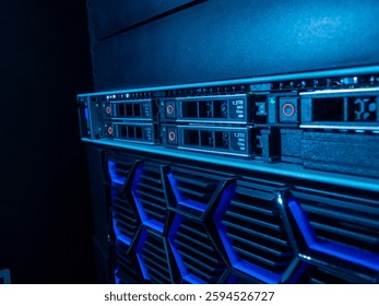 A close-up view of a modern server unit showcasing blue LED indicators and various storage components, representing cutting-edge data management technology.