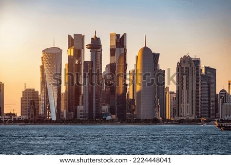 Closeup view of the modern skyline of Doha, Qatar, with the skyscrapers shining in sunset light