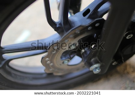 Close-up view of motorcycle brakes in the front wheel. Stock photos of disc brakes on scooter or motorcycle
