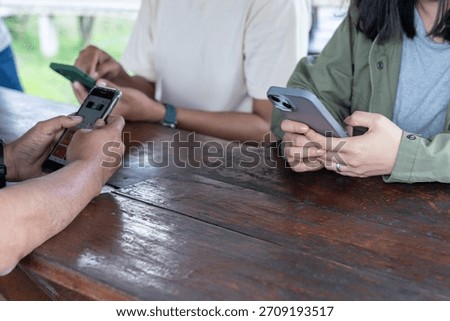 A close-up view of multiple people using smartphones, symbolizing modern social media interaction.