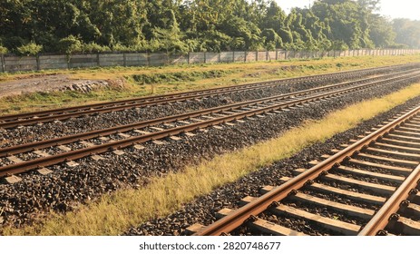 Close-up view of a multi-track railway line stretching into the distance under a clear blue sky