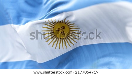 Close-up view of the national flag of the Argentine Republic. South American country. Horizontal triband of light blue (top and bottom) and white with a Sun of May centered on the white band.
