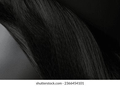 Close-up view of natural shiny dark hair, bunch of black brunette curls background - Shutterstock ID 2366454101