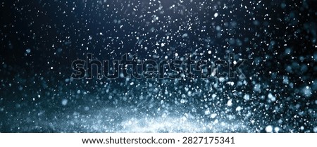 Close-up view of numerous small, bright particles suspended in a dark, fluid medium, possibly water or space, with subtle light effects.