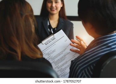 Close-up View Of Office Job Interviews With HR Personnel Holding Resume And Background Checks On Applicants With Prepared Skills.