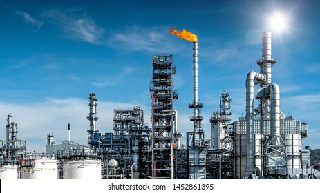 Close-up view Oil and gas industrial refinery zone,Detail of equipment oil pipeline steel with valve from large oil storage tank at cloudy sky. -image - Powered by Shutterstock