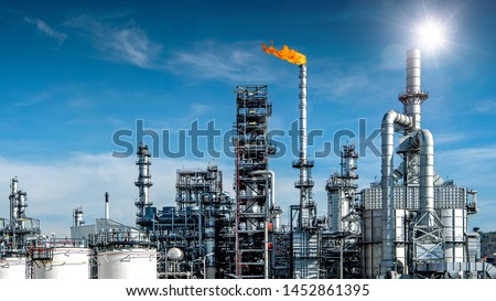 Close-up view Oil and gas industrial refinery zone,Detail of equipment oil pipeline steel with valve from large oil storage tank at cloudy sky. -image