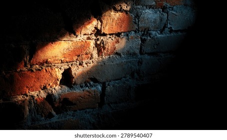 A close-up view of an old brick wall, with a dramatic shaft of warm sunlight highlighting the rough texture and imperfections of the bricks.
