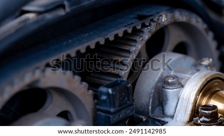 A close-up view of an old car engine showing various gears and machinery. Sensor camshaft.