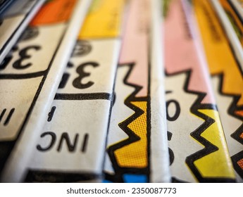 Closeup view of an old comic book collection stacked in a pile creates a colorful background paper texture with abstract shapes