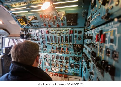 Close-up View Of Old Large Passenger Aircraft Cockpit. Flight Engineer Seating At Engine Control Panel