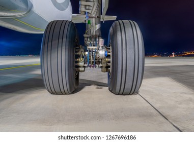 Close-up View On Airbus A320-232 Aircraft's Left Main Landing Gear At Night. Tbilisi International Airport, Tbilisi, Georgia