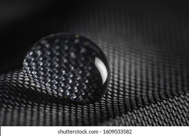 Close-up View On Water Drop On Waterproof Impregnated Fabric Of Black Umbrella.