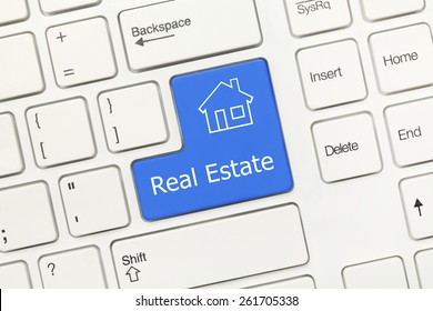Close-up view on white conceptual keyboard - Real Estate (blue key)