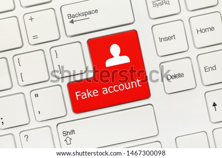 Close-up view on white conceptual keyboard - Fake account (red key)