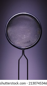 Closeup View Of One Metal Strainer On Purple Background, Minimalistic Approach, Studio Composition. 