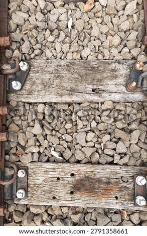 Close-up view of one or two old wooden railway sleepers showing weathered wood grain and signs of long-term use