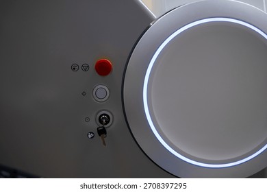 A close-up view of the operational control panel on the main unit of the ZEISS VISUMAX 800 Femtosecond Laser System, featuring the emergency stop, key lock, and a prominent illuminated housing