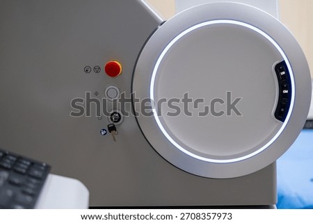A close-up view of the operational control panel on the main unit of the ZEISS VISUMAX 800 Femtosecond Laser System, featuring the emergency stop, key lock, and a prominent illuminated housing