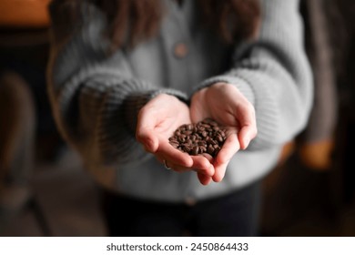 Close-Up View of a Pair of Hands Gently Holding Fresh Coffee Beans