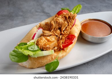 A closeup view of a pan con pollo.