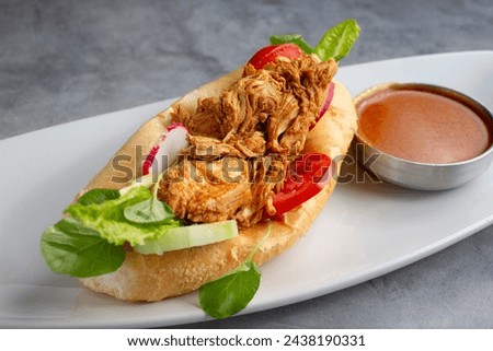 A closeup view of a pan con pollo.