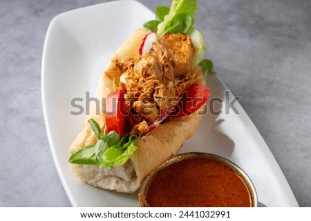A closeup view of a pan con pollo.