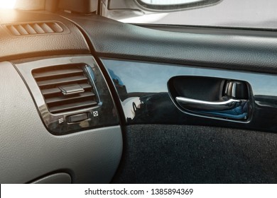 A Close-up View Of A Part Of The Interior Of A Modern Luxury Car With A View Of A Silver-colored Door Handle On A Chrome Finish With Black Wood Trim After Dry Cleaning. Auto Service Industry. 