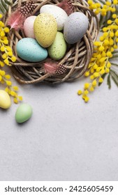 A close-up view of pastel-colored Easter eggs in a small basket, decorated with yellow spring flowers, symbolizing Easter celebration.