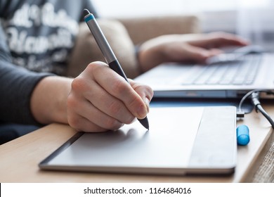 Close-up view at pen of drawing board painting on surface, woman illustrator in work - Powered by Shutterstock