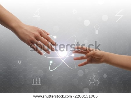 Closeup view of people and virtual model of atom on light grey background