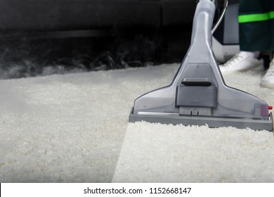 Close-up View Of Person Cleaning White Carpet With Professional Vacuum Cleaner 