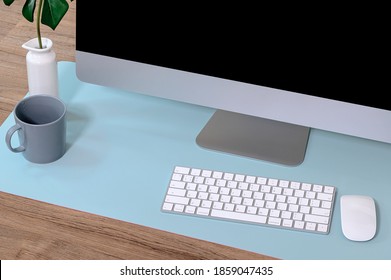 Closeup View Of Personal Computer With Keyboard And Mouse On Light Blue Pad.