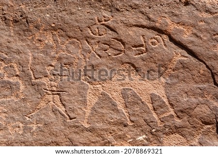 Closeup view of a petroglyph featuring a camel and a man in Wadi Rum, Jordan