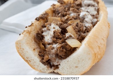 A closeup view of a Philly cheesesteak sandwich.