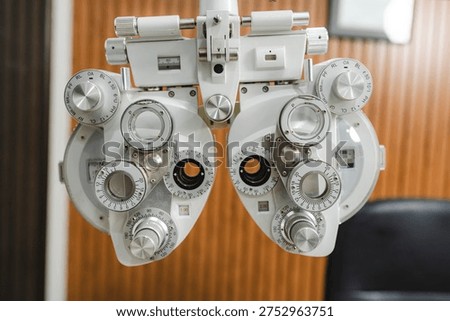 Close-up view of a phoropter in an optometry clinic, precision optical instrument used for refractive eye exams and vision testing to determine corrective lens prescriptions
