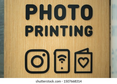 Close-up View Of The Photo Printing Sign