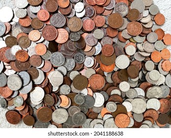 Close-up view of a pile of british coins of varying denominations,