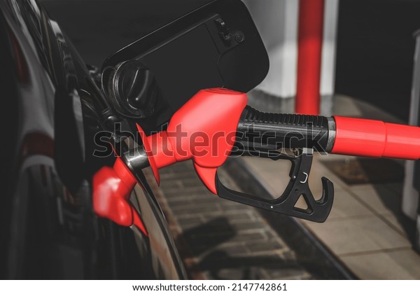 Close-up view, Pistol of gas station is inserted\
into the tank car for\
refuel