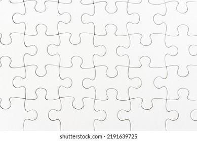 close-up view of plain white jigsaw puzzle background - Shutterstock ID 2191639725