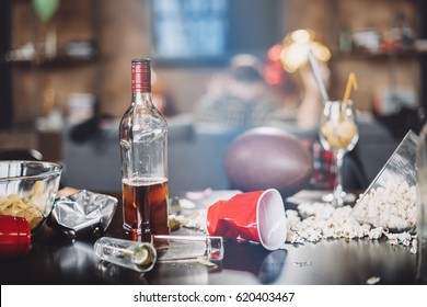 Close-up view of popcorn, glasses and trash on messy table after party 