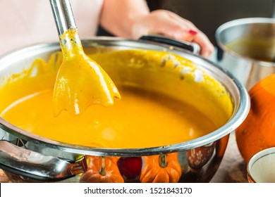 close-up view of preparing pumpkin soup puree with mixer