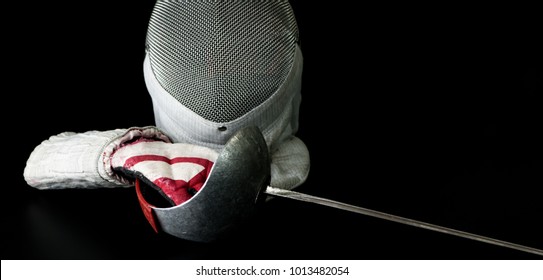 Close-up View Of Professional Fencing Protective Equipment For Sabre Is, Fencing Mask, Fencing Glove And Rapier On Black Background