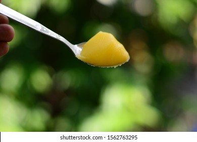 Closeup View Of Pure Ghee On A Spoon.