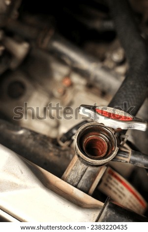 closeup view of radiator cap to control and Refill radiator water. vertical image