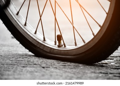 Closeup view of rear flat tire of vintage bicycle which parked on pavement beside the road. soft and selective focus. - Powered by Shutterstock