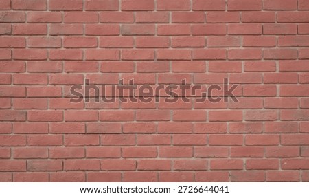 A close-up view of a red brick wall with a uniform pattern of bricks, showcasing the texture and color of the bricks.